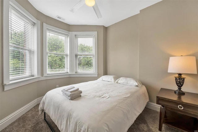 carpeted bedroom with baseboards and ceiling fan
