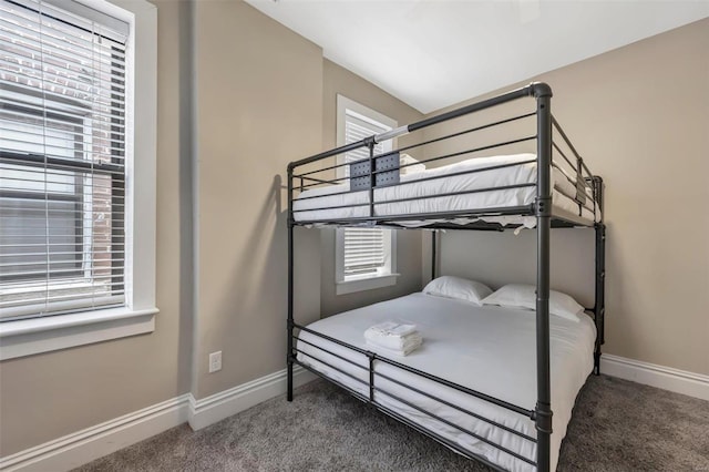 bedroom featuring carpet floors and baseboards