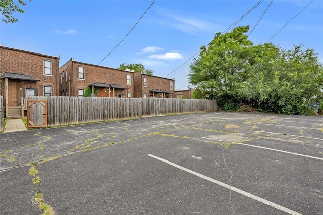 uncovered parking lot featuring fence