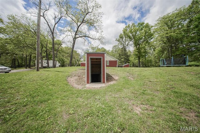 12455 Jefferys Pl, Rolla, MO 65401 - view of grassy yard with a trampoline and an outdoor structure