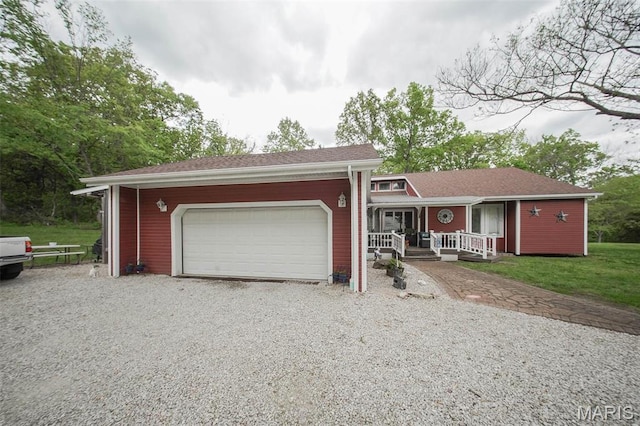 12455 Jefferys Pl, Rolla, MO 65401 - view of front of property with gravel driveway, covered porch, an attached garage, and a front yard