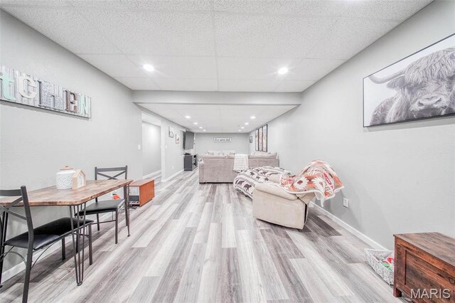 12455 Jefferys Pl, Rolla, MO 65401 - living area featuring light wood-style floors, a paneled ceiling, and baseboards