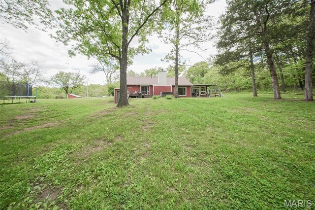 12455 Jefferys Pl, Rolla, MO 65401 - view of green lawn featuring a trampoline and an outdoor structure