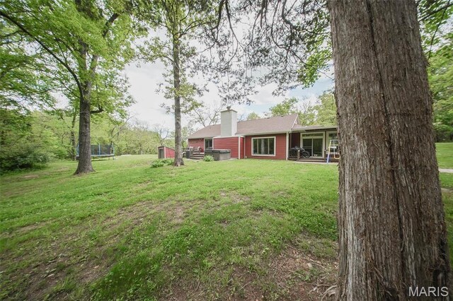 12455 Jefferys Pl, Rolla, MO 65401 - view of green lawn with a trampoline and a patio area