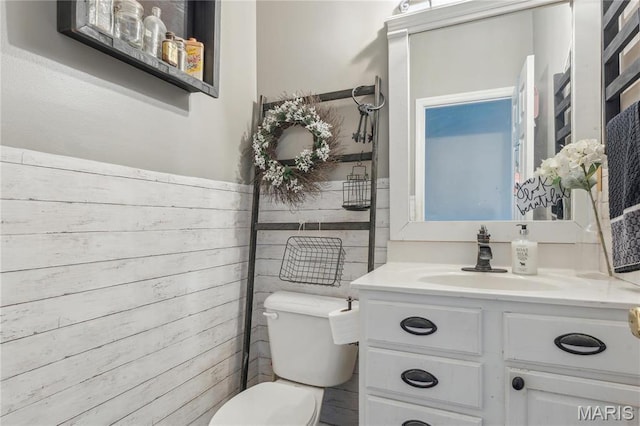 8038 Fox Holw, Barnhart, MO 63012 - half bathroom featuring toilet, vanity, and wooden walls