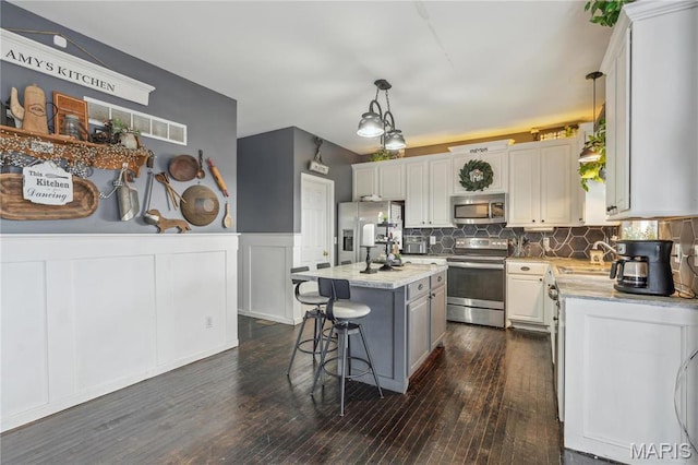 8038 Fox Holw, Barnhart, MO 63012 - kitchen with appliances with stainless steel finishes, a kitchen breakfast bar, light countertops, tasteful backsplash, and a center island