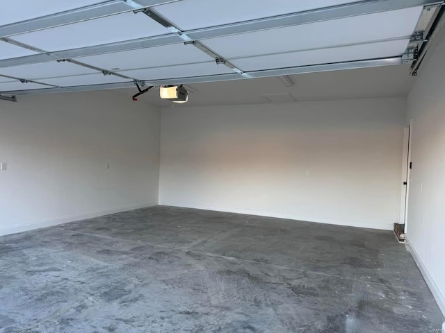 garage with a garage door opener and baseboards