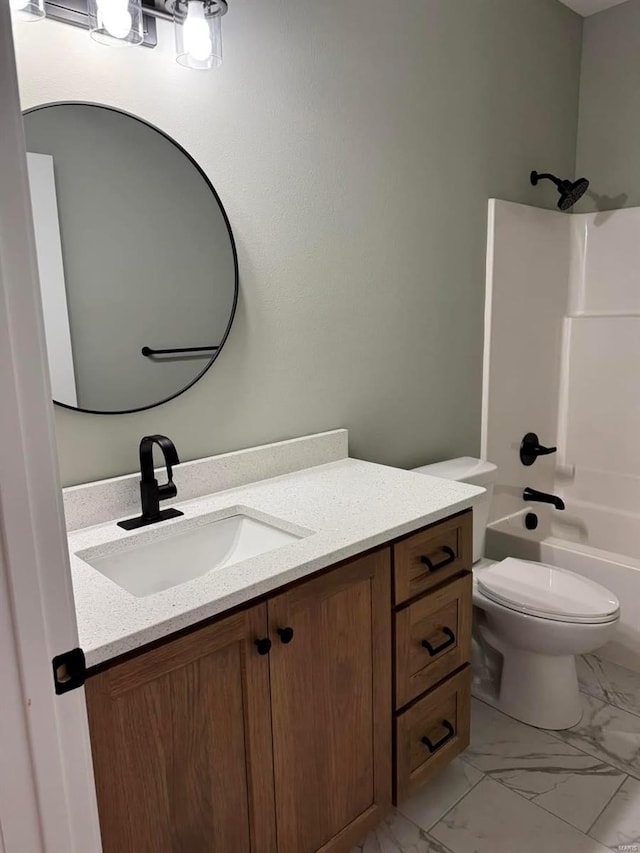 bathroom with vanity, toilet, bathing tub / shower combination, and marble look tiles