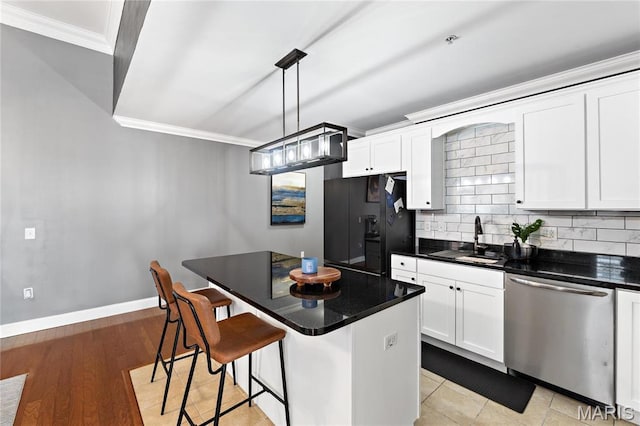 kitchen with stainless steel dishwasher, crown molding, black fridge with ice dispenser, a sink, and tasteful backsplash