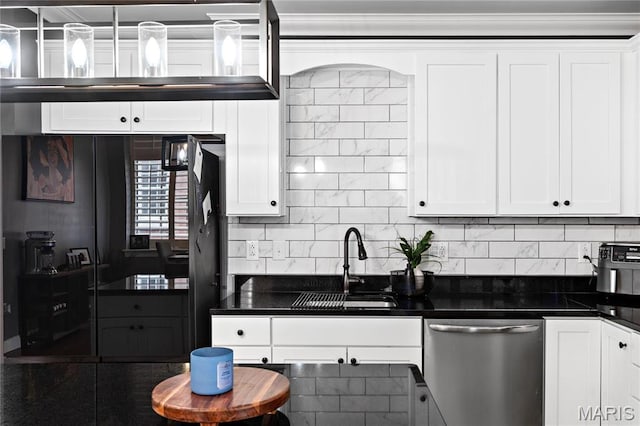 kitchen with stainless steel dishwasher, a sink, dark countertops, white cabinets, and crown molding