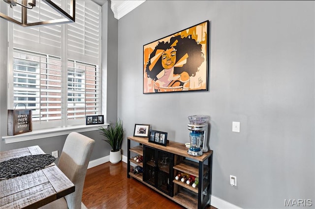 home office featuring baseboards, wood finished floors, and ornamental molding