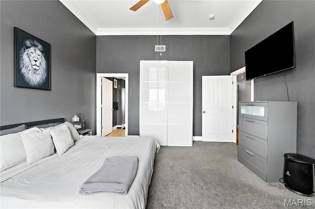 bedroom with crown molding, carpet flooring, and ceiling fan