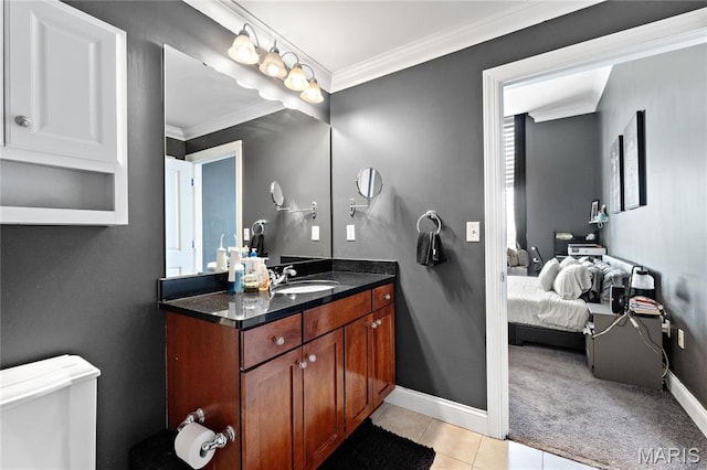 bathroom with crown molding, tile patterned flooring, baseboards, toilet, and vanity
