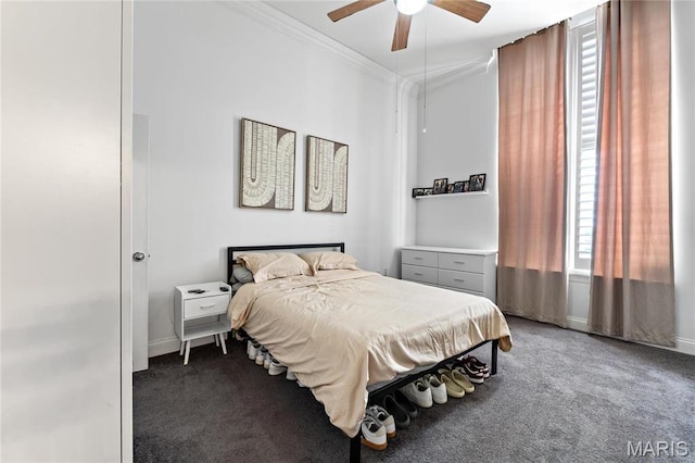 bedroom with carpet, ornamental molding, baseboards, and ceiling fan