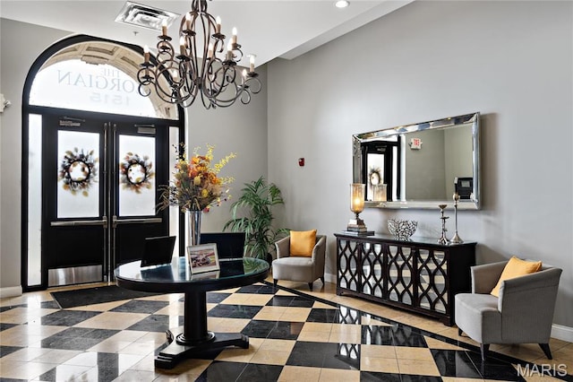 tiled foyer entrance with baseboards, a chandelier, and recessed lighting