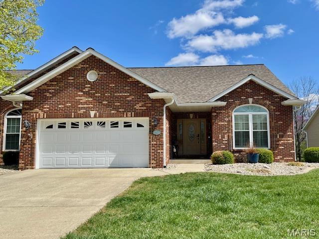 112 Summit Rdg, Maryville, IL 62062 - view of front of house featuring a garage, driveway, brick siding, a front yard, and roof with shingles