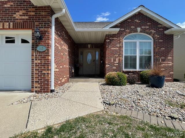 112 Summit Rdg, Maryville, IL 62062 - property entrance featuring brick siding, a garage, and a shingled roof