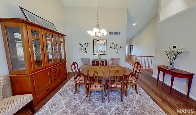112 Summit Rdg, Maryville, IL 62062 - dining room featuring dark wood finished floors, a chandelier, high vaulted ceiling, baseboards, and recessed lighting