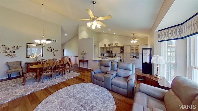 112 Summit Rdg, Maryville, IL 62062 - living room with high vaulted ceiling, wood finished floors, baseboards, ceiling fan, and a chandelier