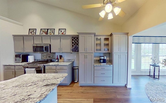 112 Summit Rdg, Maryville, IL 62062 - kitchen with stainless steel appliances, gray cabinetry, light wood-type flooring, ceiling fan, and light stone counters