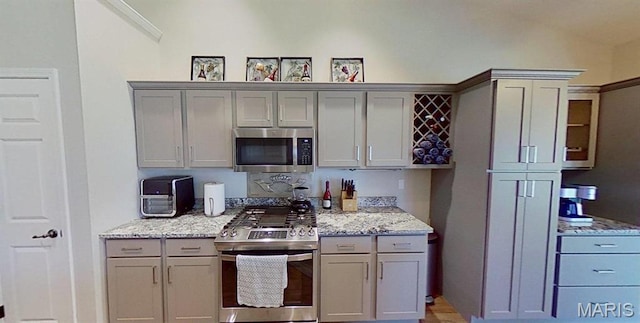 112 Summit Rdg, Maryville, IL 62062 - kitchen with stainless steel appliances, gray cabinetry, and light stone countertops