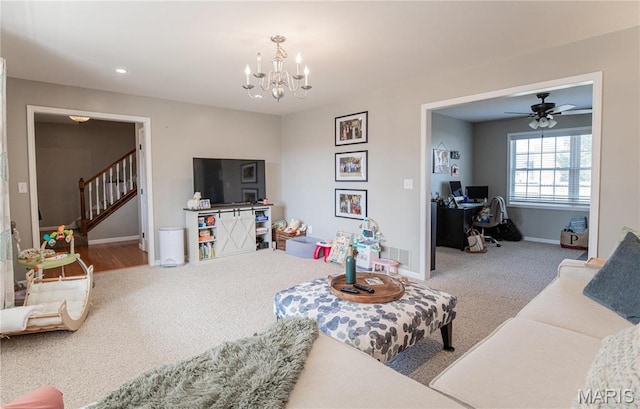 carpeted living room with an office area, baseboards, a chandelier, stairway, and a ceiling fan