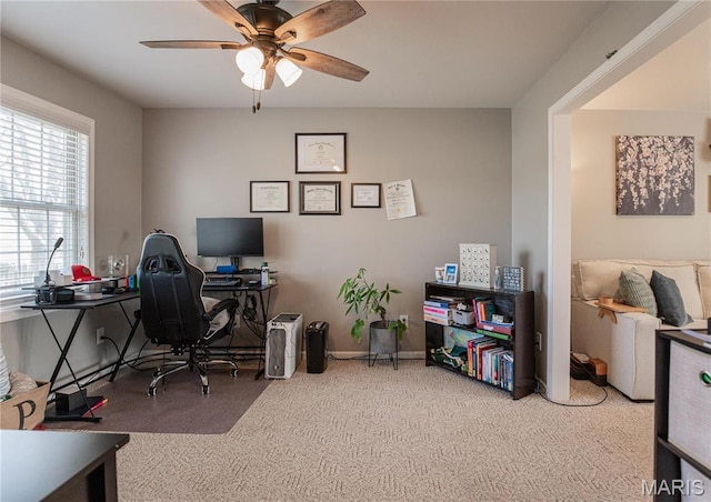 carpeted home office with ceiling fan
