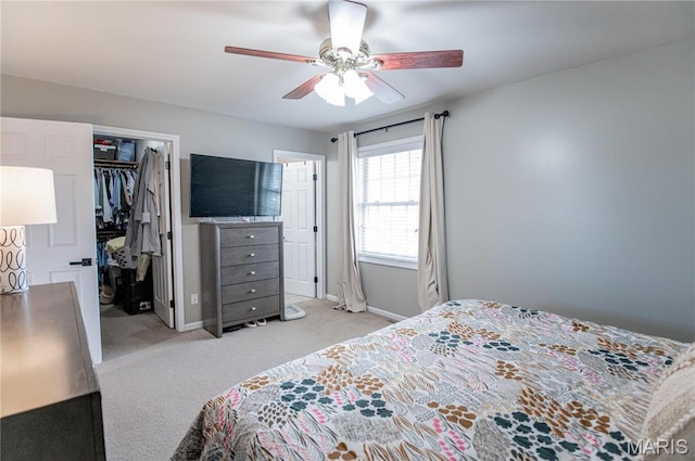 bedroom with light colored carpet, baseboards, and a ceiling fan