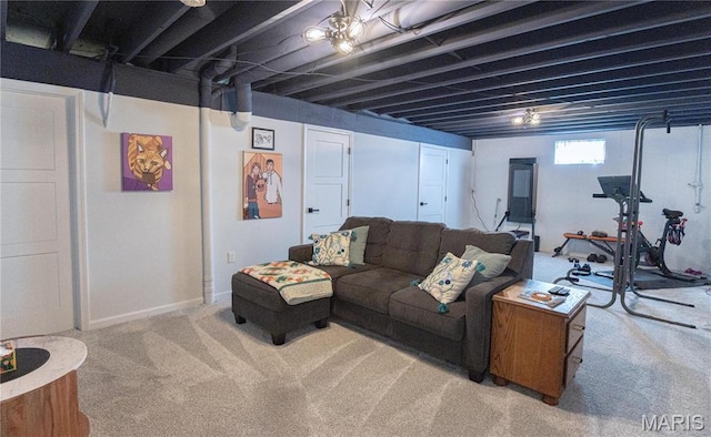 carpeted living area featuring baseboards
