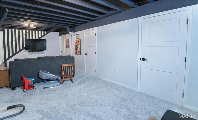 finished below grade area featuring carpet flooring and baseboards