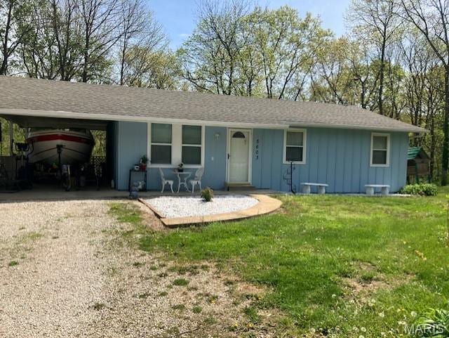 5603 Carter Dr, House Springs, MO 63051 - view of front of property featuring driveway, board and batten siding, a front yard, a carport, and covered porch