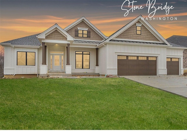 2313 Clare Ct Unit 70Stb, Washington, MO 63090 - view of front of home featuring a standing seam roof, board and batten siding, an attached garage, a lawn, and driveway