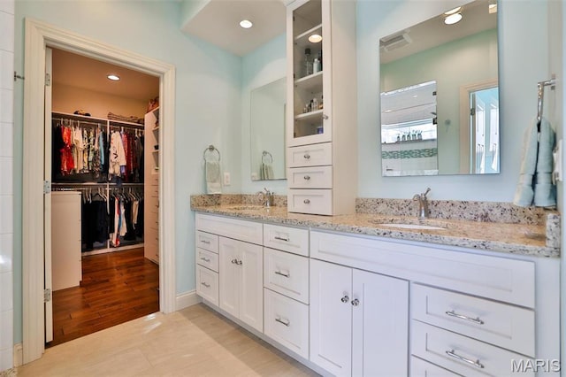 1120 Franklin Ave, Edwardsville, IL 62025 - bathroom with double vanity, a spacious closet, and recessed lighting