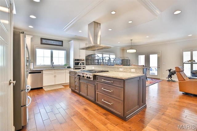 1120 Franklin Ave, Edwardsville, IL 62025 - kitchen featuring island range hood, appliances with stainless steel finishes, crown molding, open floor plan, and white cabinets