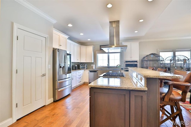 1120 Franklin Ave, Edwardsville, IL 62025 - kitchen with appliances with stainless steel finishes, a kitchen breakfast bar, ornamental molding, island range hood, and light wood-style floors