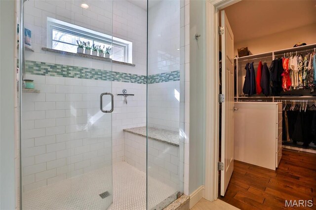 1120 Franklin Ave, Edwardsville, IL 62025 - bathroom with wood finished floors, a stall shower, and a walk in closet