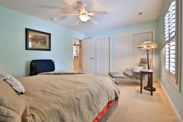 1120 Franklin Ave, Edwardsville, IL 62025 - bedroom with two closets, light colored carpet, and ceiling fan