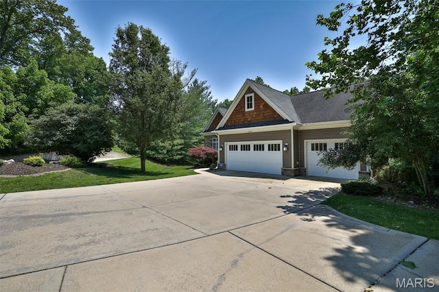 1120 Franklin Ave, Edwardsville, IL 62025 - craftsman-style house featuring driveway, an attached garage, a front yard, and stone siding
