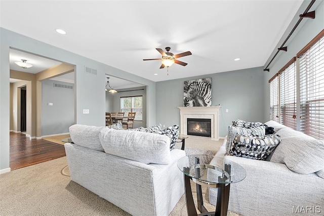 615 Derby Way Dr, Wentzville, MO 63385 - living area featuring carpet, a ceiling fan, a glass covered fireplace, recessed lighting, and wood finished floors
