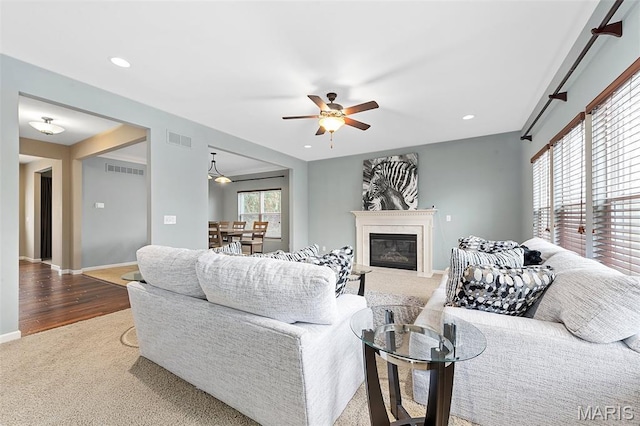 615 Derby Way Dr, Wentzville, MO 63385 - living room with a ceiling fan, a glass covered fireplace, carpet, recessed lighting, and wood finished floors