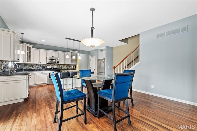 615 Derby Way Dr, Wentzville, MO 63385 - dining room with dark wood-style flooring, stairs, and recessed lighting
