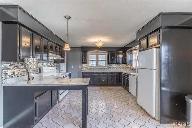 2125 Barron Rd, Poplar Bluff, MO 63901 - kitchen featuring white appliances, under cabinet range hood, tasteful backsplash, light countertops, and decorative light fixtures