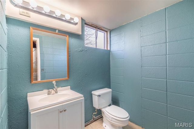 2125 Barron Rd, Poplar Bluff, MO 63901 - half bath featuring vanity, a textured wall, and tile patterned floors