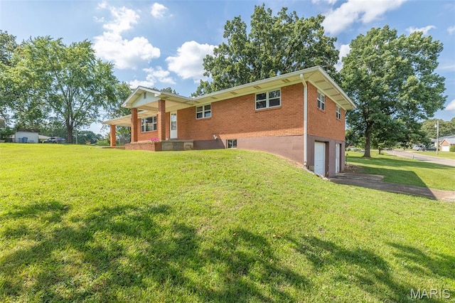 2125 Barron Rd, Poplar Bluff, MO 63901 - back of house with an attached garage, brick siding, asphalt driveway, and a yard