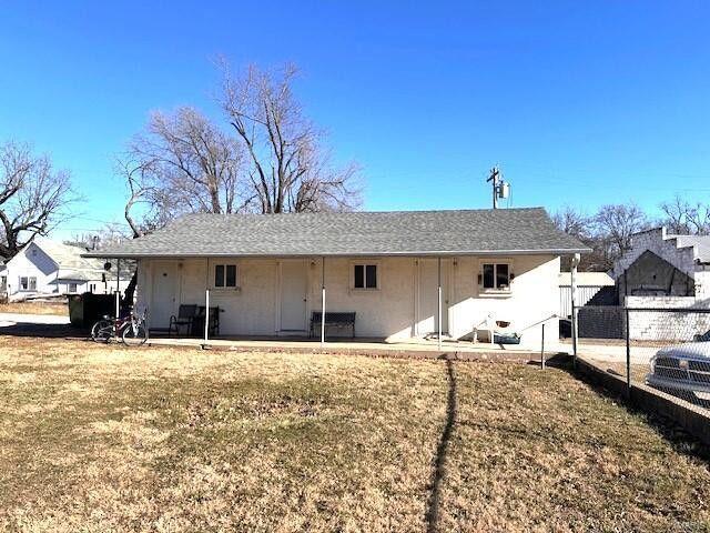 back of property with a patio and fence