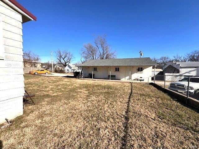 rear view of property featuring fence