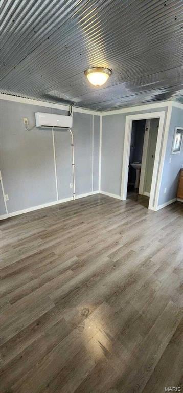 305 E Main St, Willow Springs, MO 65793 - below grade area featuring a wall unit AC and wood finished floors