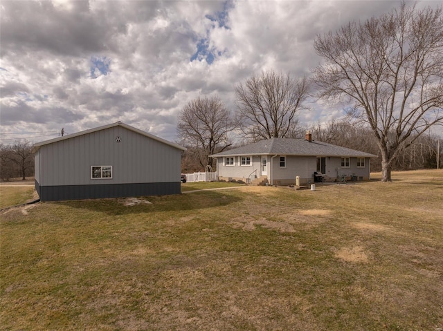 rear view of property with a yard and a chimney