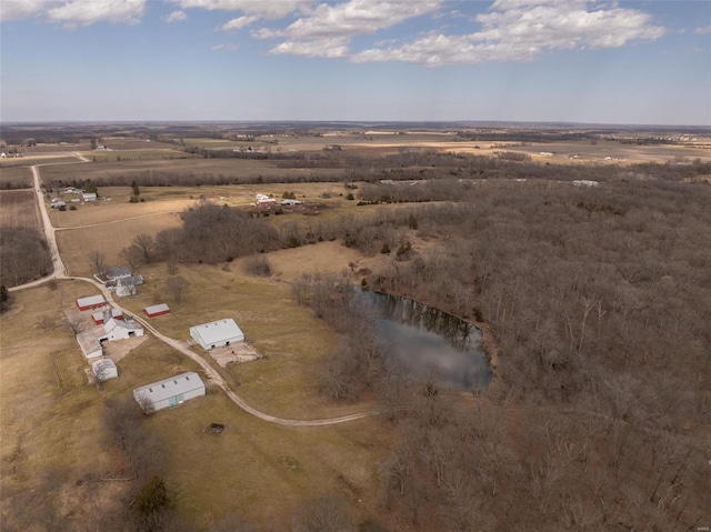 aerial view of property and surrounding area featuring rural landscape and a nearby body of water