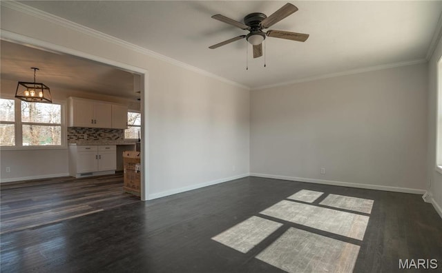 514 W Missouri St, Bloomfield, MO 63825 - unfurnished living room with dark wood-type flooring, a ceiling fan, baseboards, and ornamental molding